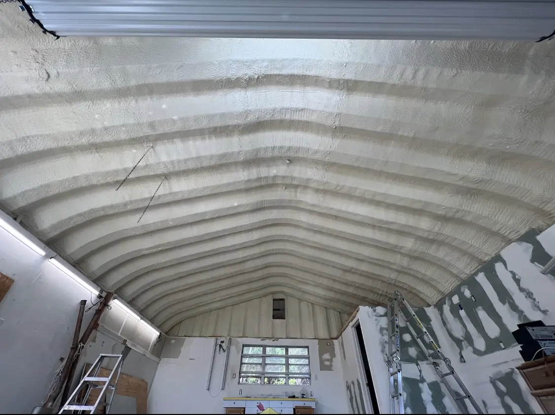 Spray polyurethane foam applied to the underside of a metal roof deck in Fairmont
